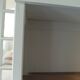 Shallow depth bookcase re-enchanted in pearl gray, wooden shelves.