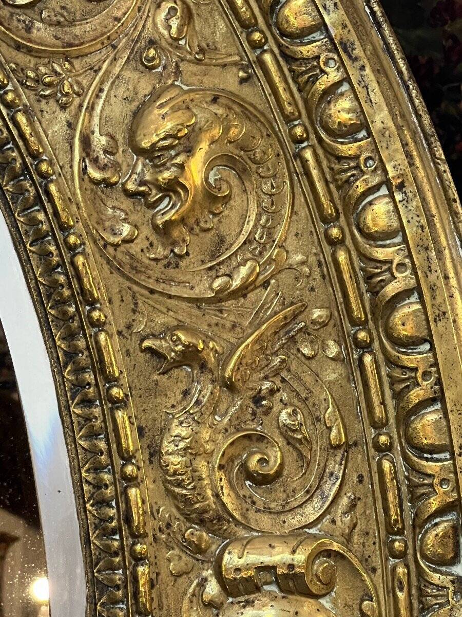 A. Arens, Antwerp, important oval mirror in repoussé brass with numerous animal decorations