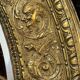 A. Arens, Antwerp, important oval mirror in repoussé brass with numerous animal decorations