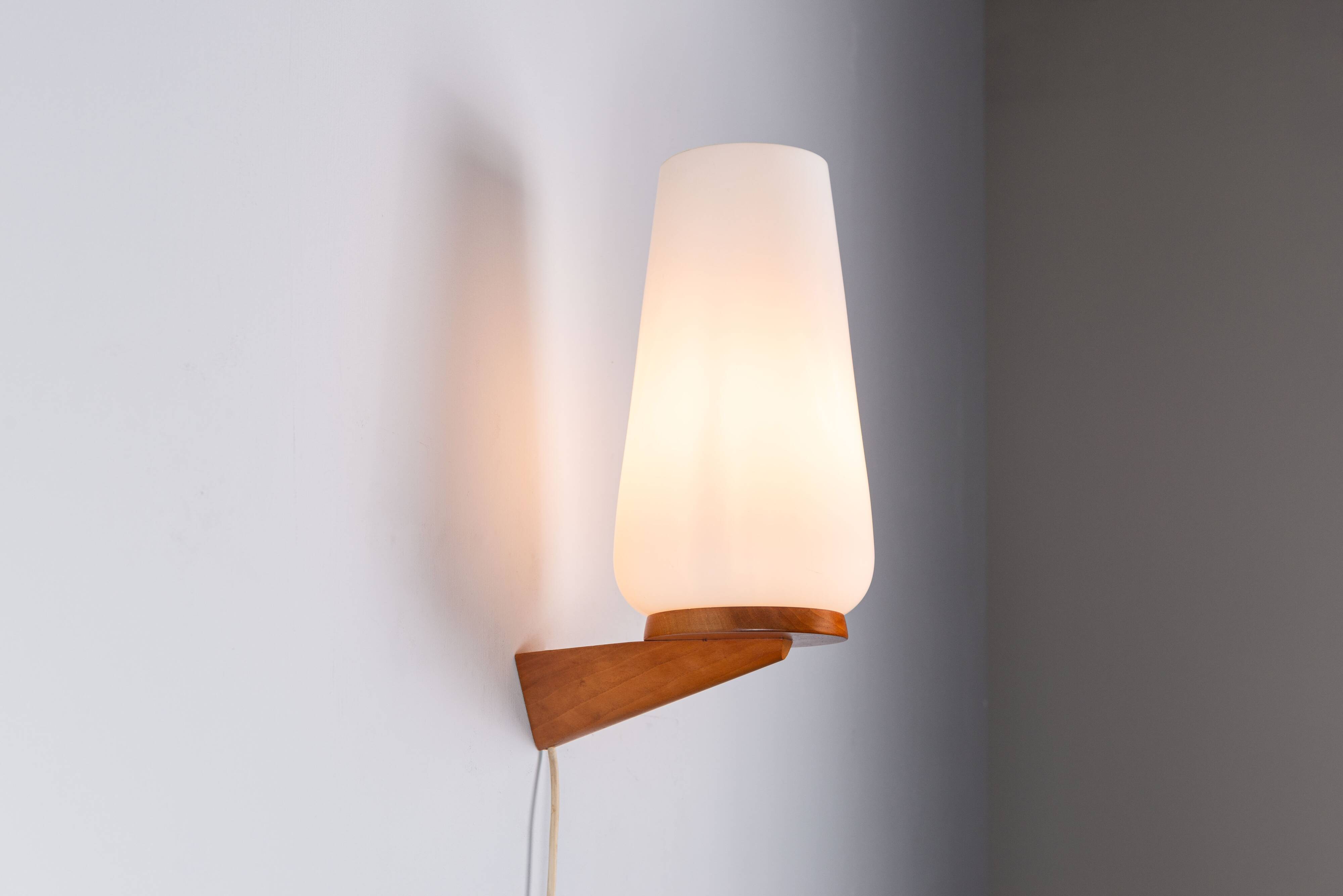 Wall lamp with opal glass shade on wooden base by Philips