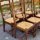 6 solid wood chairs in dark oak with a glossy finish and straw.