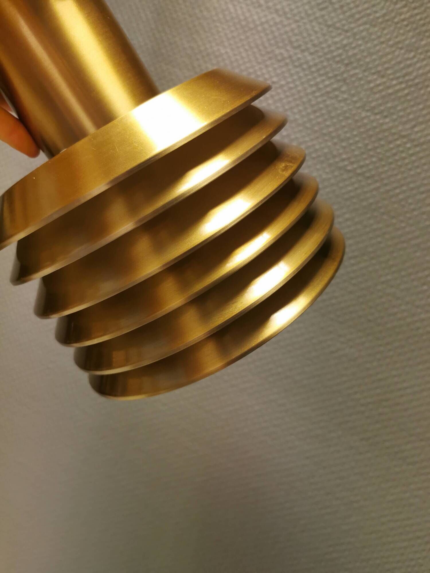 Hanging lamp in gold-colored aluminum with many layers of shades.