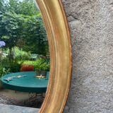 Golden oval mirror
