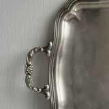 Silver metal serving tray with sculpted handles