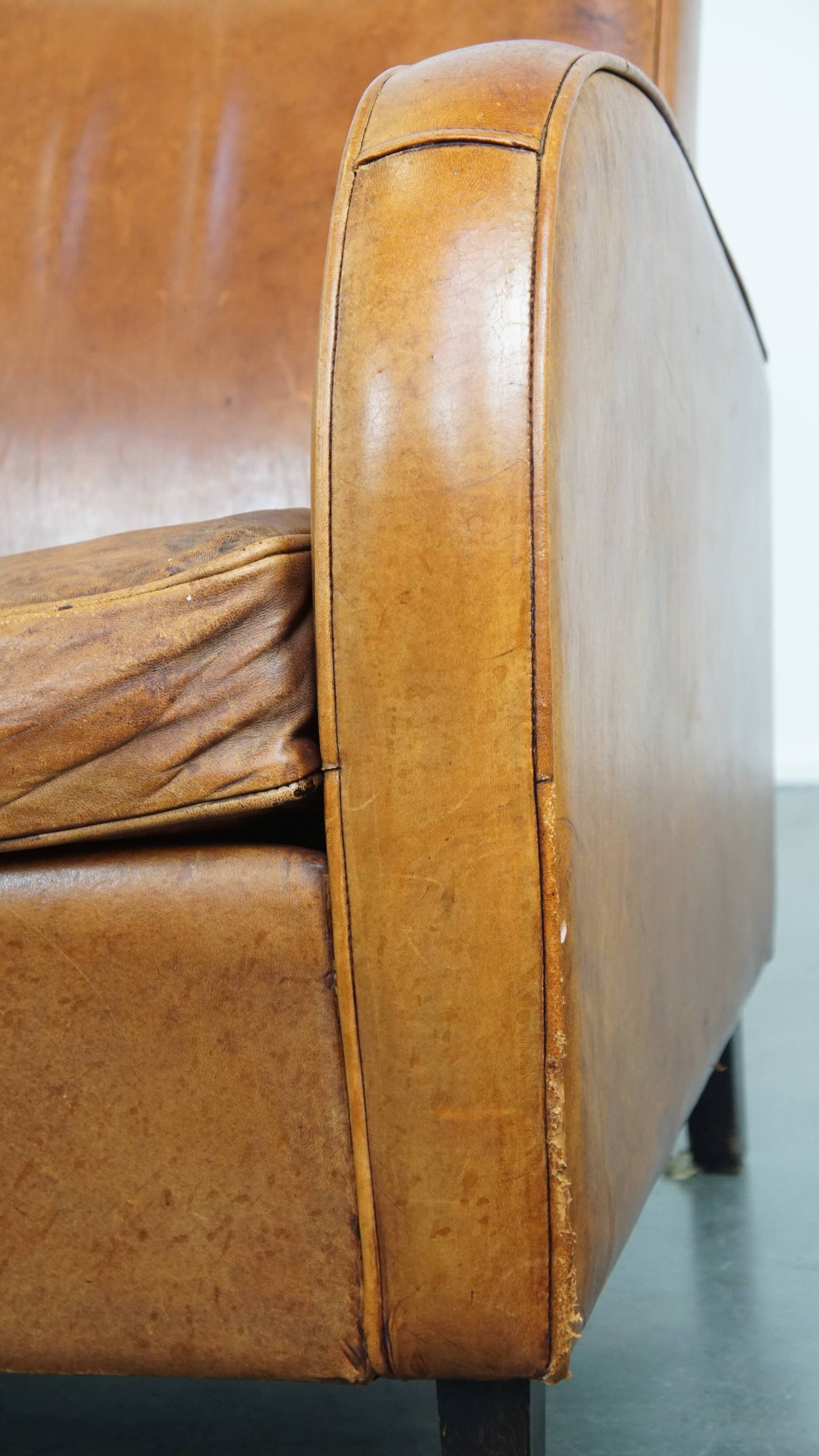 Characteristic sheepskin design armchair in beautiful warm cognac colours