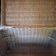 Wicker travel trunk XIX with metal clasps and handles.