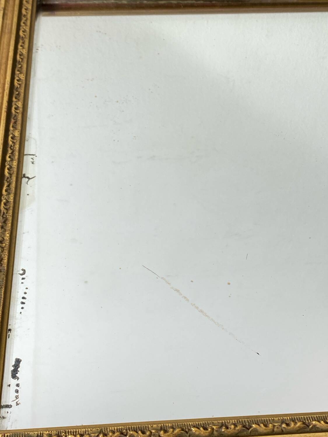 Antique mirror in carved gilded wood