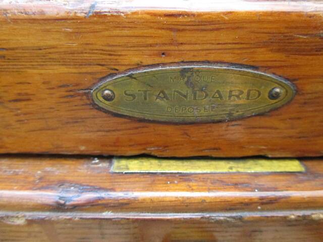 Antique oak filing cabinet with 4 drawers.