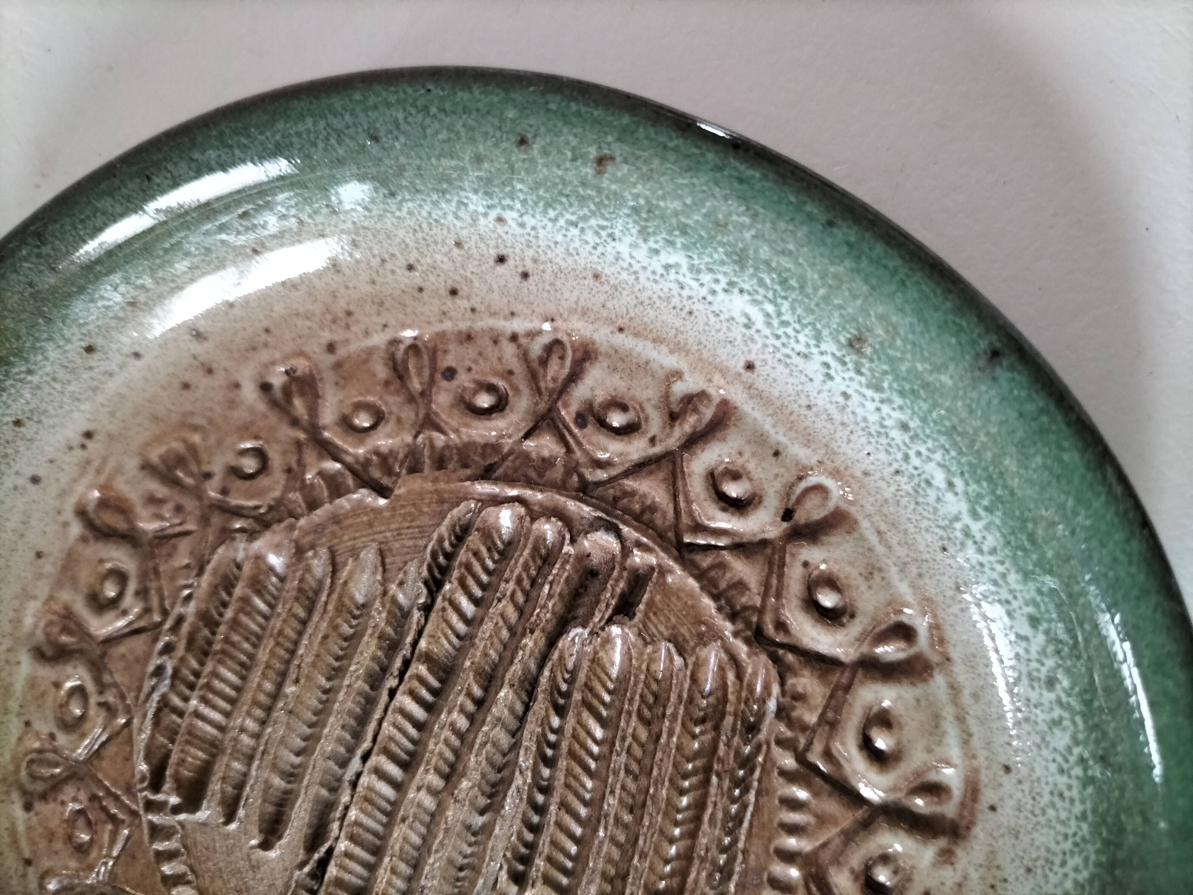 Signed stoneware bowl from Puisaye, relief decoration.