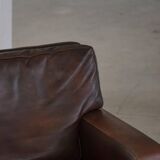 Pair of modern Danish lounge chairs in dark brown leather and rosewood, 1960s.