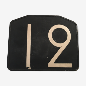 Old plate of bakelite, no. 12 bus line.