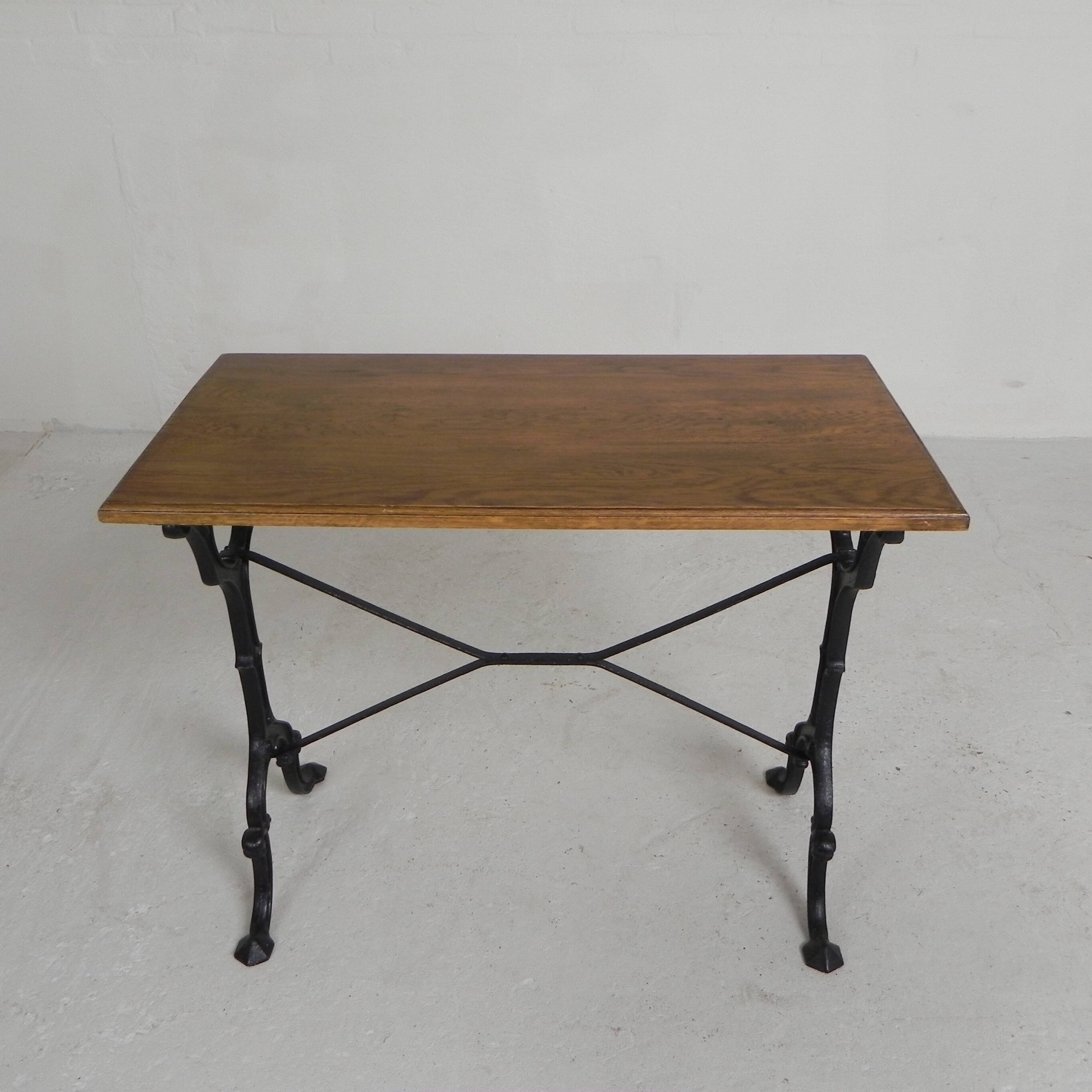 Bistro table with an oak top on a cast iron base, 1930s.
