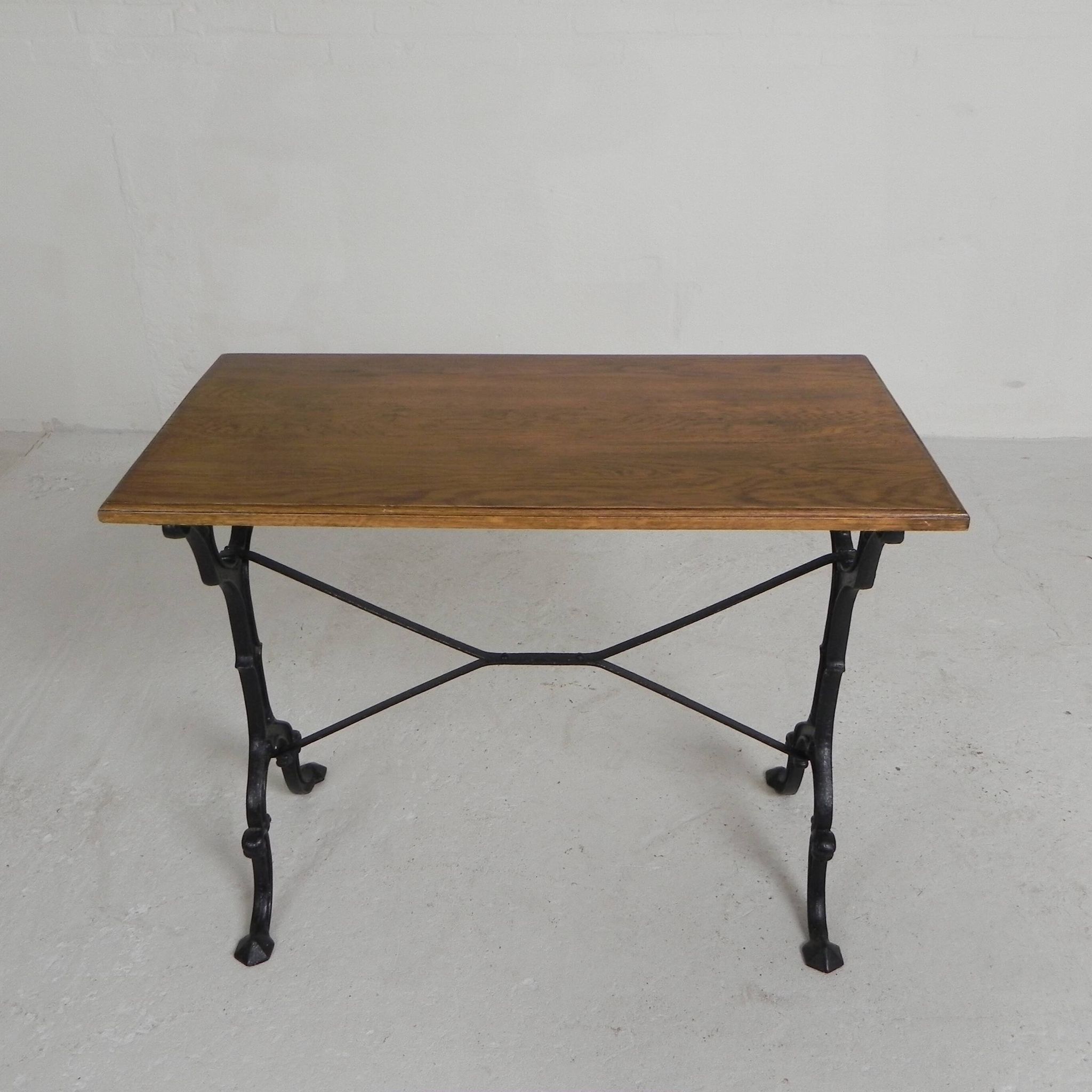 Bistro table with an oak top on a cast iron base, 1930s.