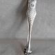 Antique silver-plated sugar tongs with lion's paws.