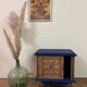 Small vintage upcycled side table in midnight blue and raw wood, with a rose-shaped door.