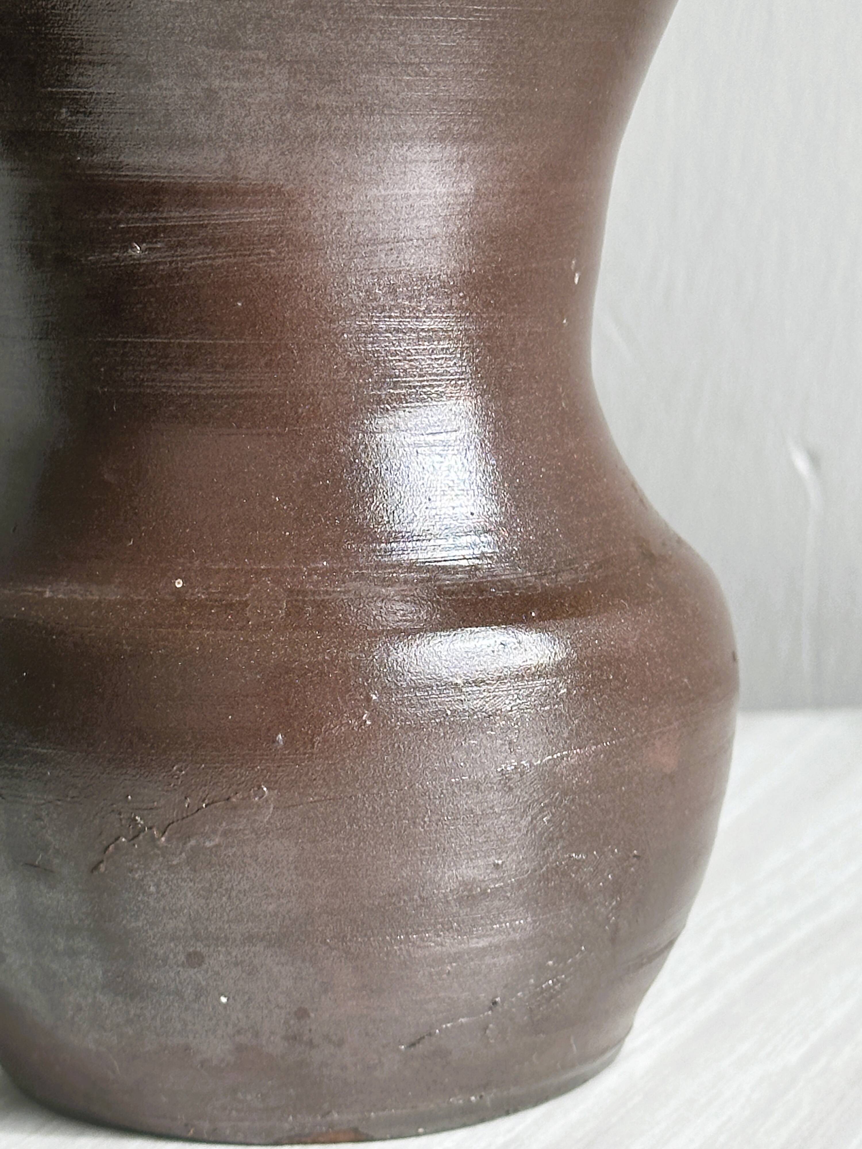 Dark brown ceramic vase, flared shape, smooth finish, classic style