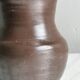 Dark brown ceramic vase, flared shape, smooth finish, classic style