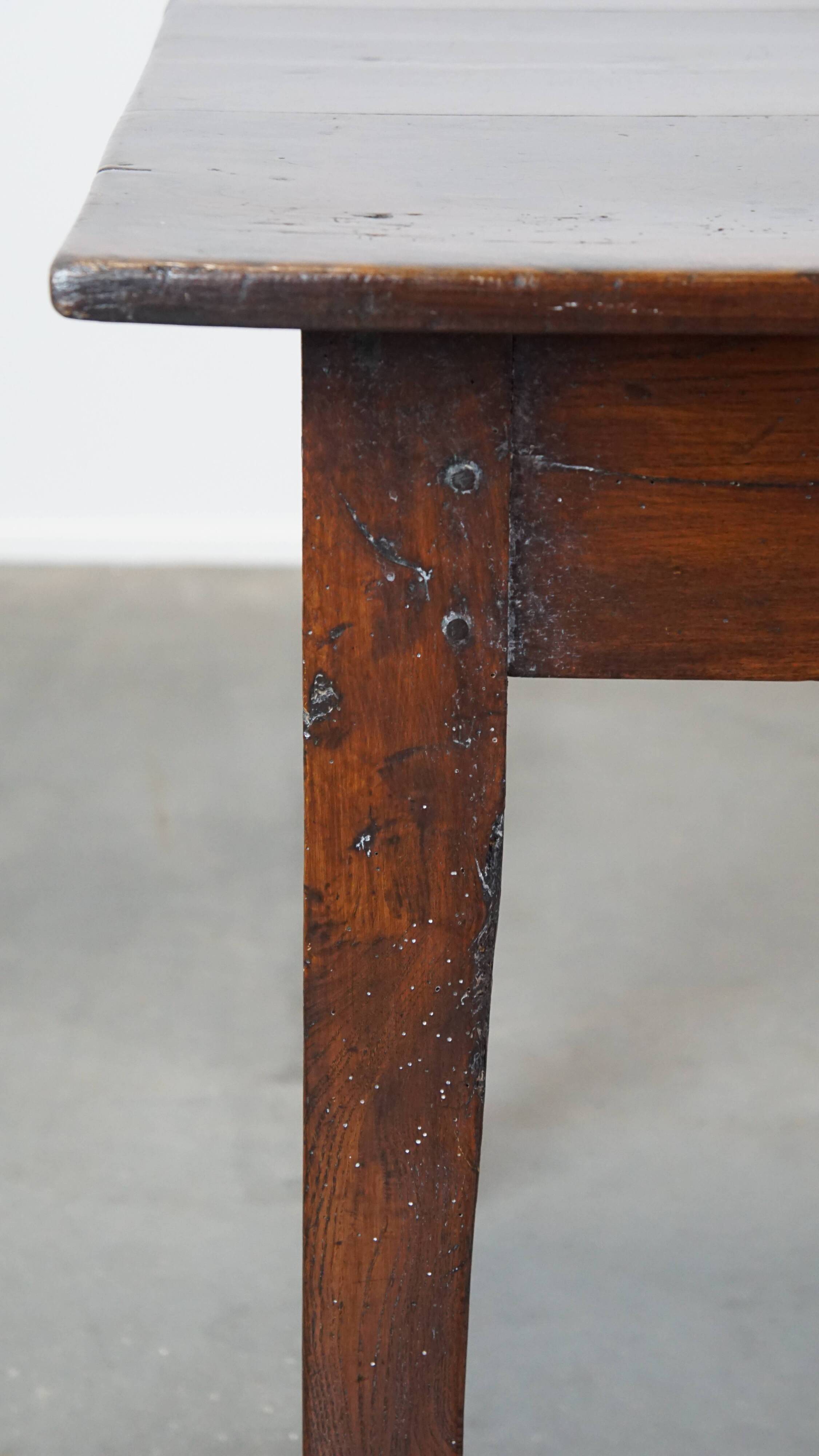 Antique French fruitwood dining table with 2 drawers and patina