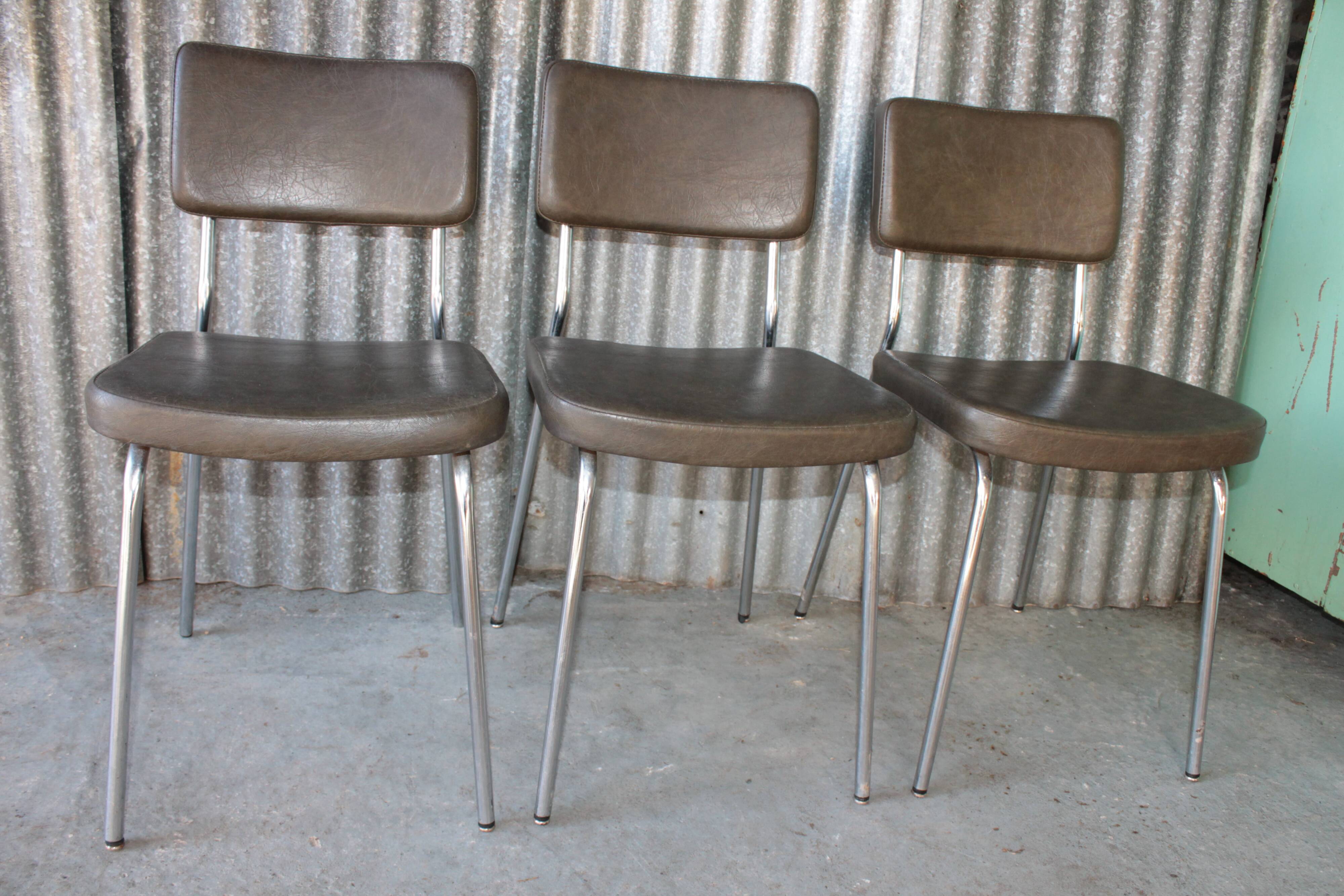 3 bronze-green faux leather chairs with chrome frames