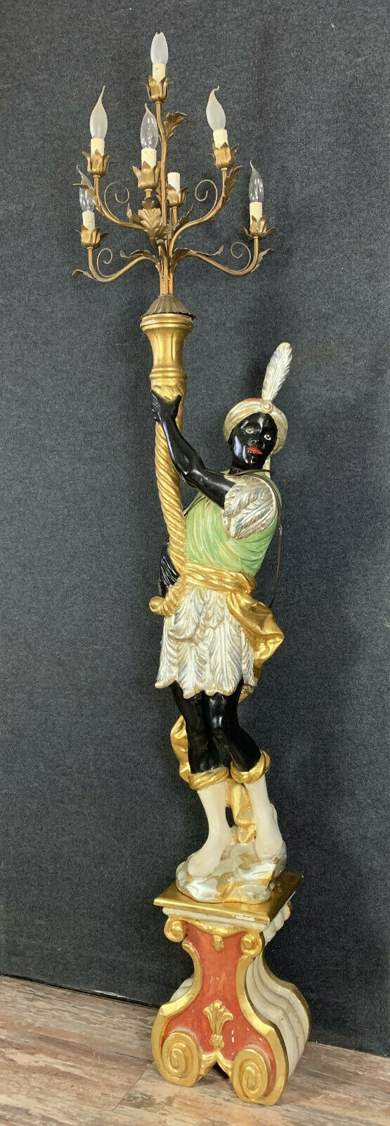 Early XXth era polychrome wooden torch has figuration of a Moor in traditional costume from the 18th