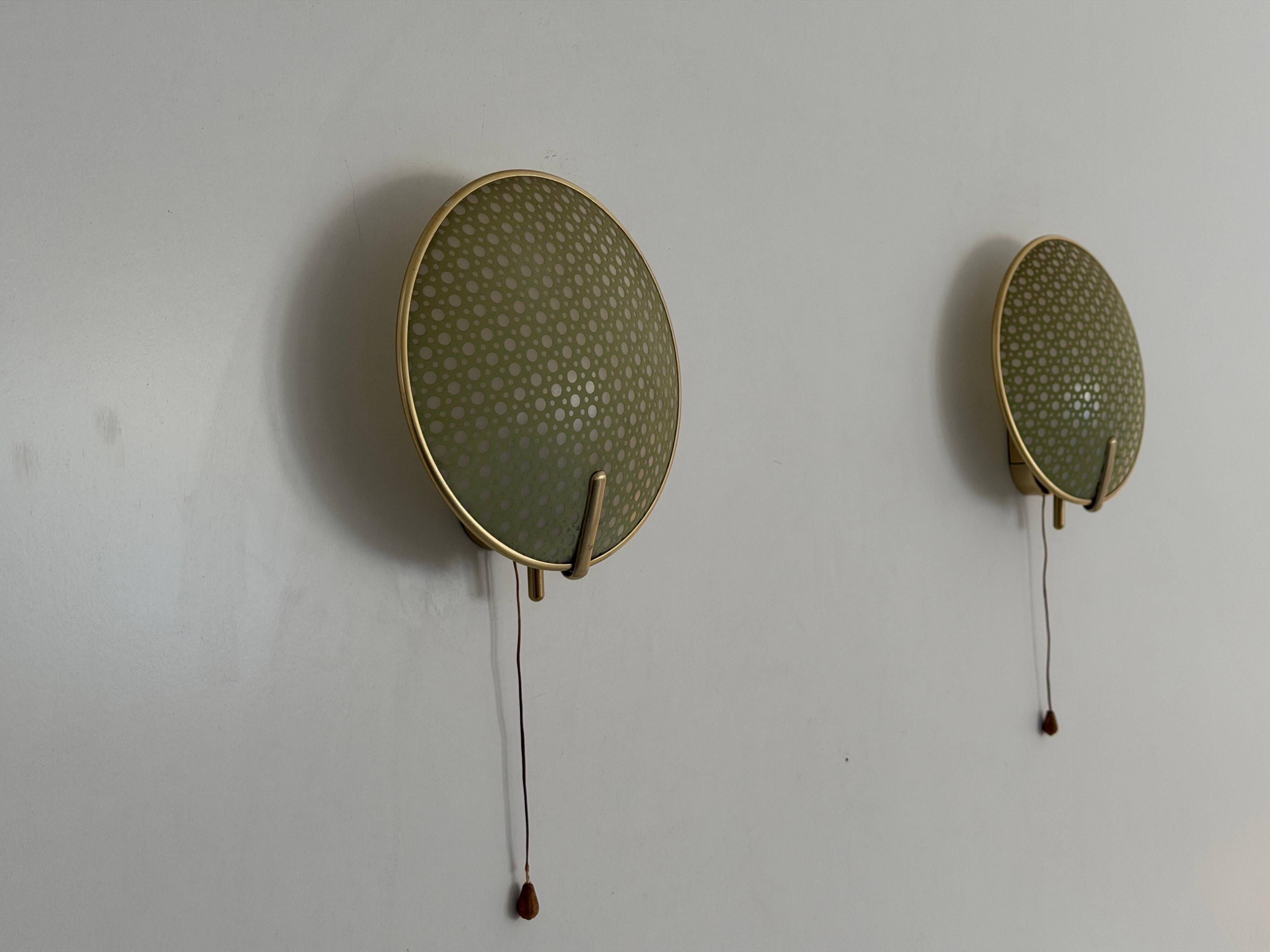Pair of green plexiglass and gold metal wall lights by Erco, 1950s, Germany.