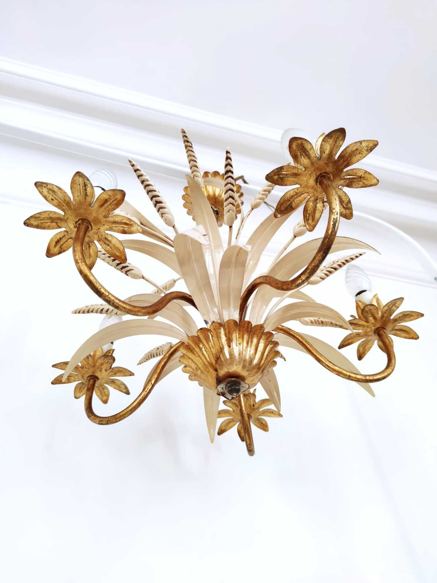 Vintage wrought iron chandelier decorated with golden and beige reeds