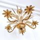 Vintage wrought iron chandelier decorated with golden and beige reeds