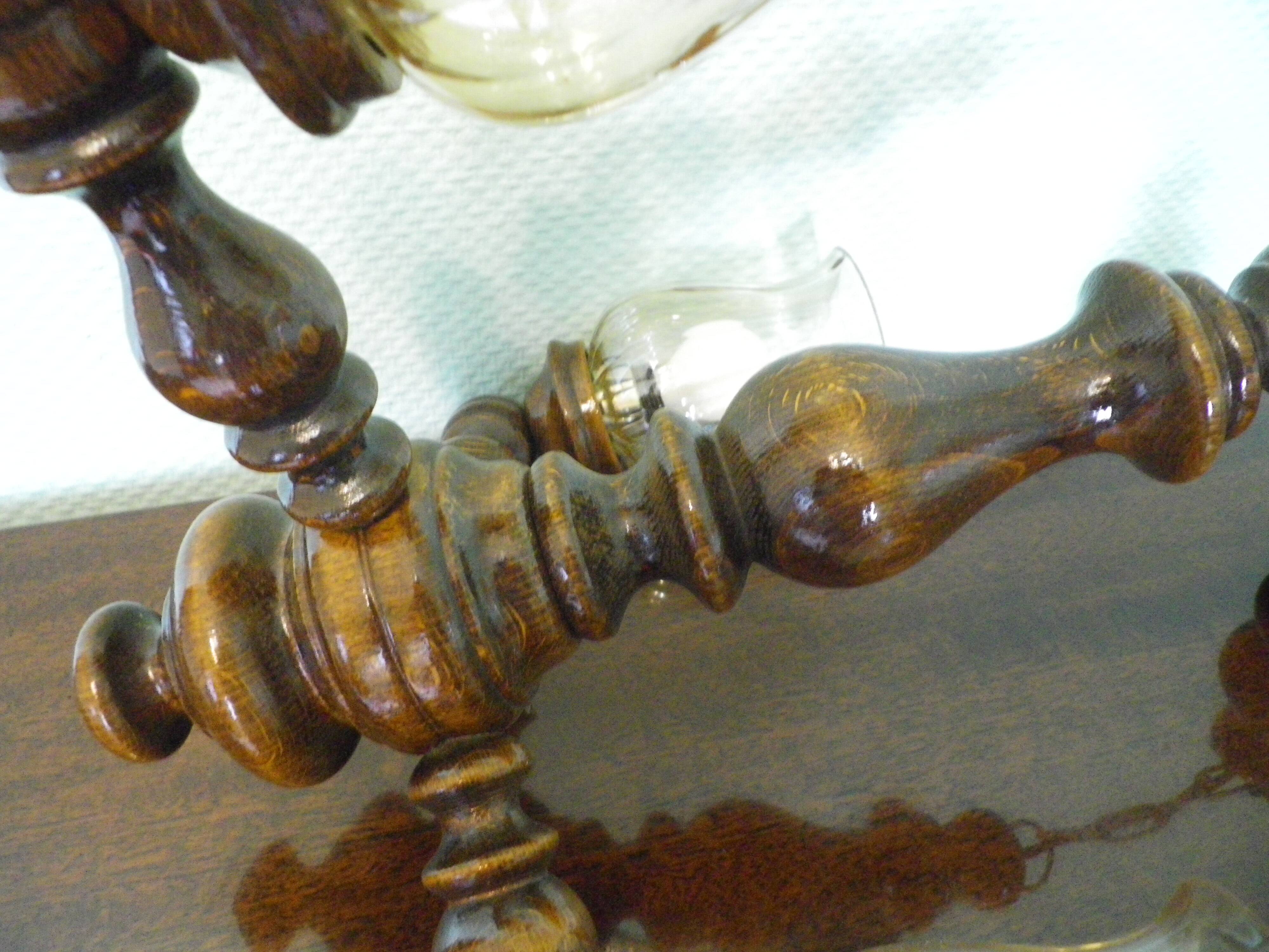 Suspension with three lights, turned varnished wood, amber tulip shade, 1970s.