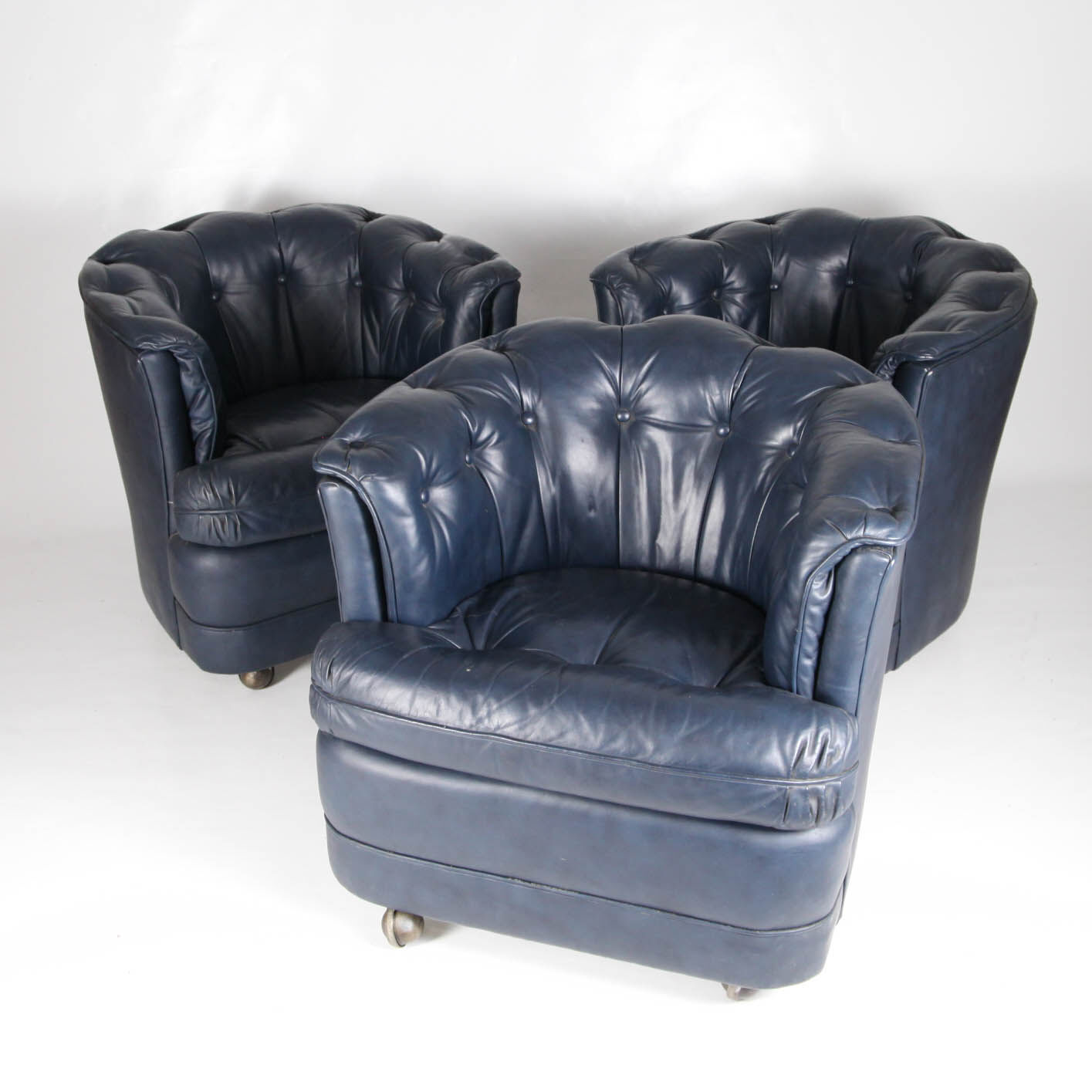 Suite of 3 small armchairs in midnight blue leather with castors