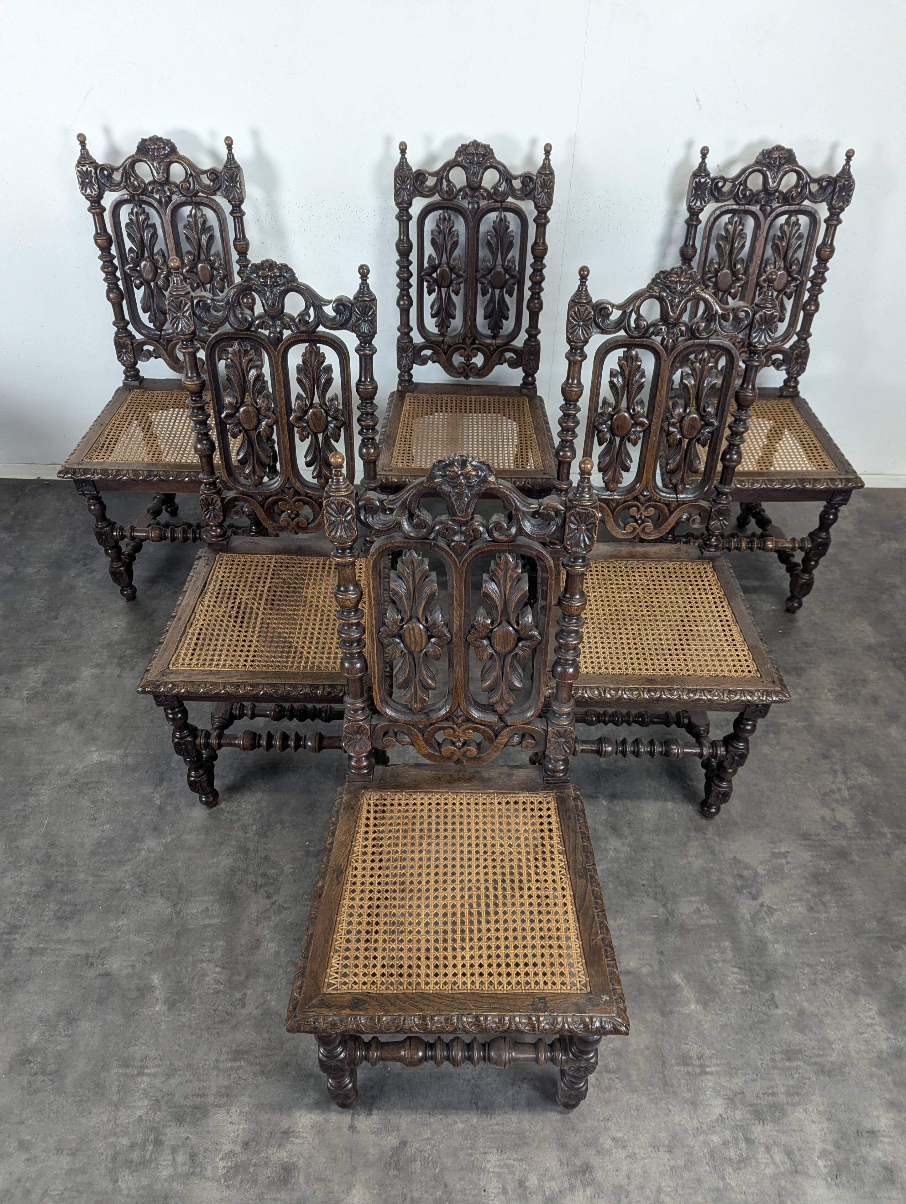 Set of 6 Henri II chairs in carved openwork oak with caned seats.