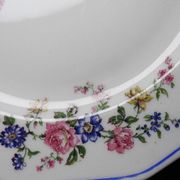 4 flat plates by Bernardaud, Limoges porcelain, floral decoration from the 1920s to 1950s.