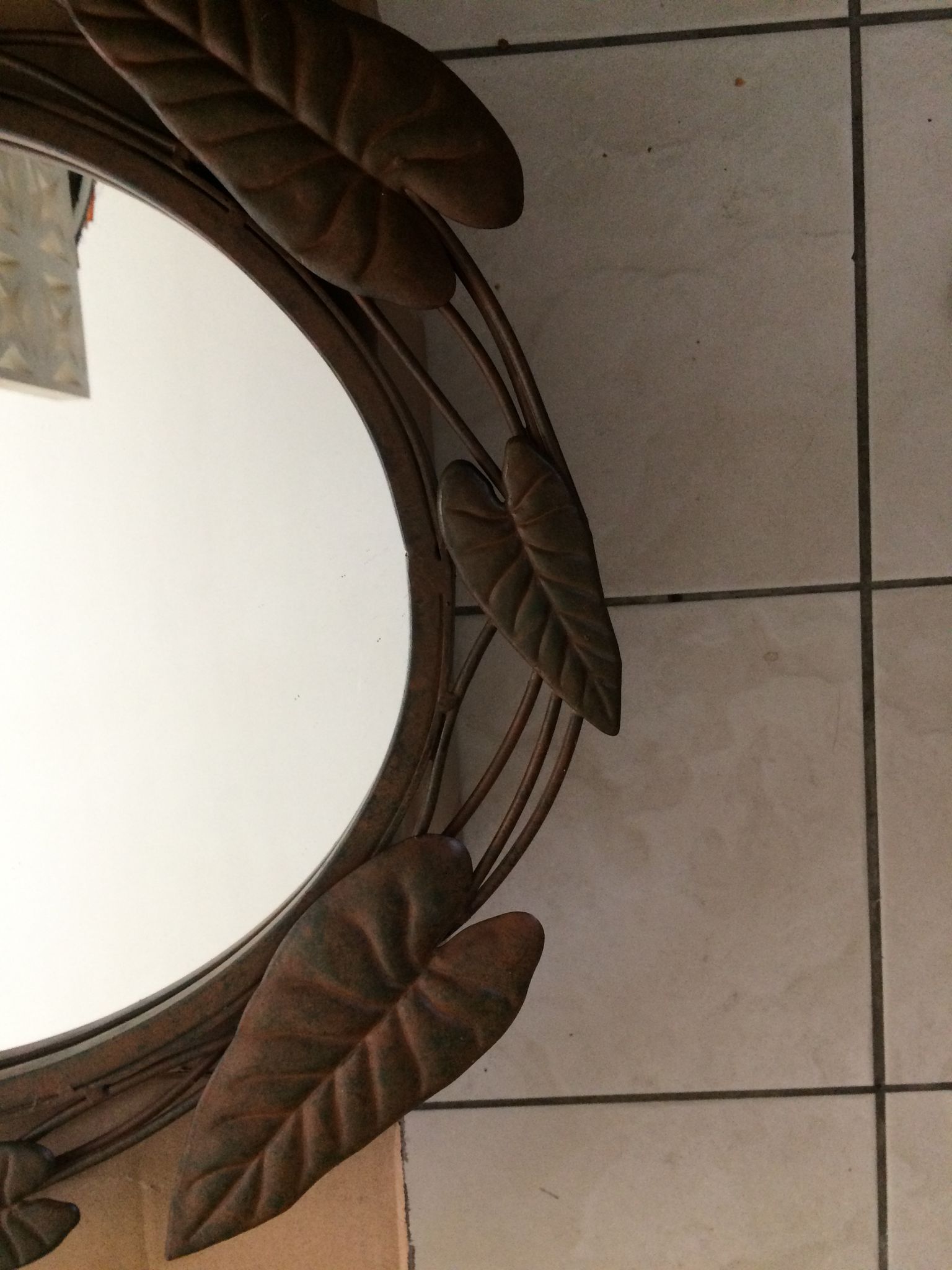 Miroir ovale entourage fer forgé en forme de fleurs et feuillage noir 69x55cm