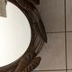 Miroir ovale entourage fer forgé en forme de fleurs et feuillage noir 69x55cm