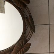 Miroir ovale entourage fer forgé en forme de fleurs et feuillage noir 69x55cm