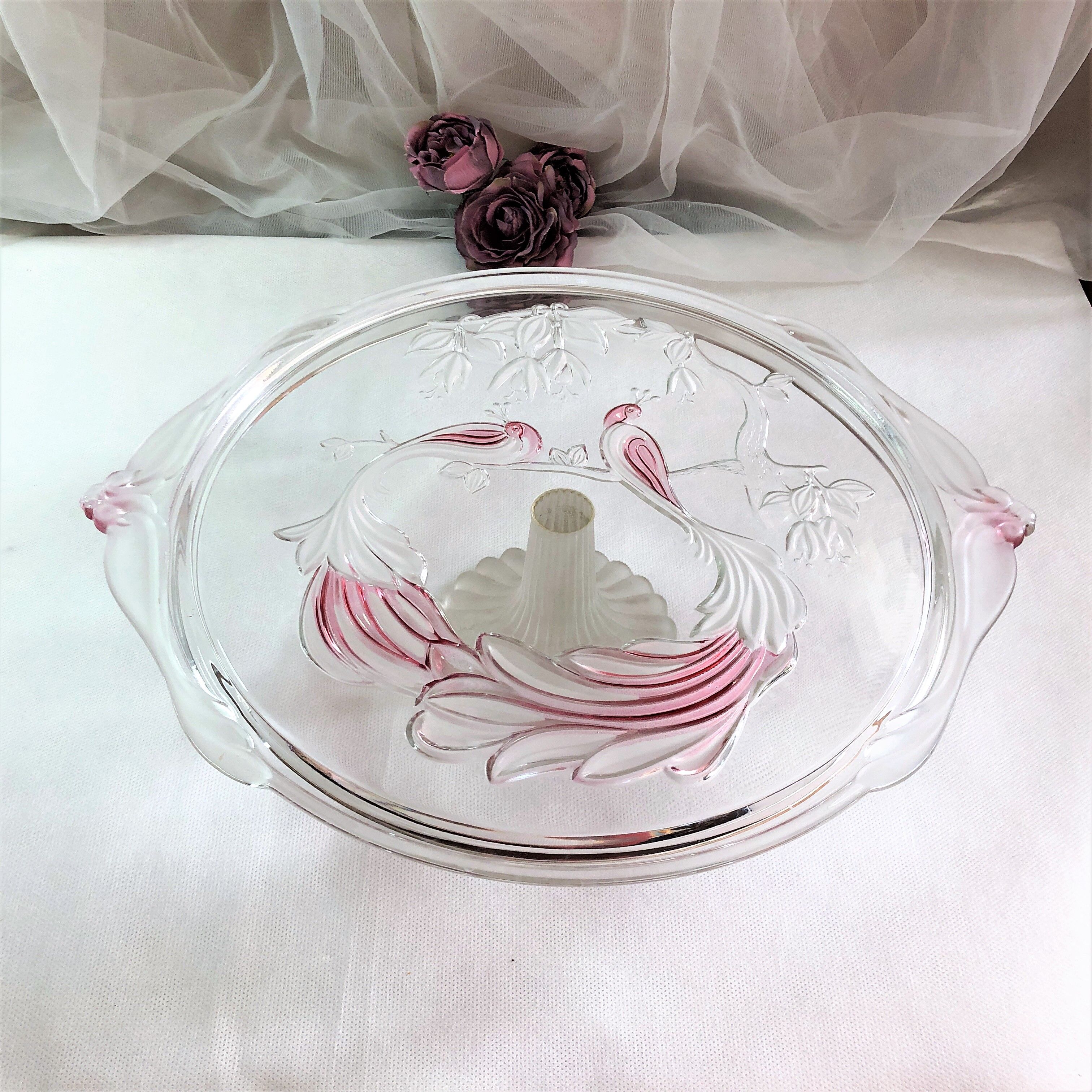 Large pie dish cakes on pedestal decorated with peacocks