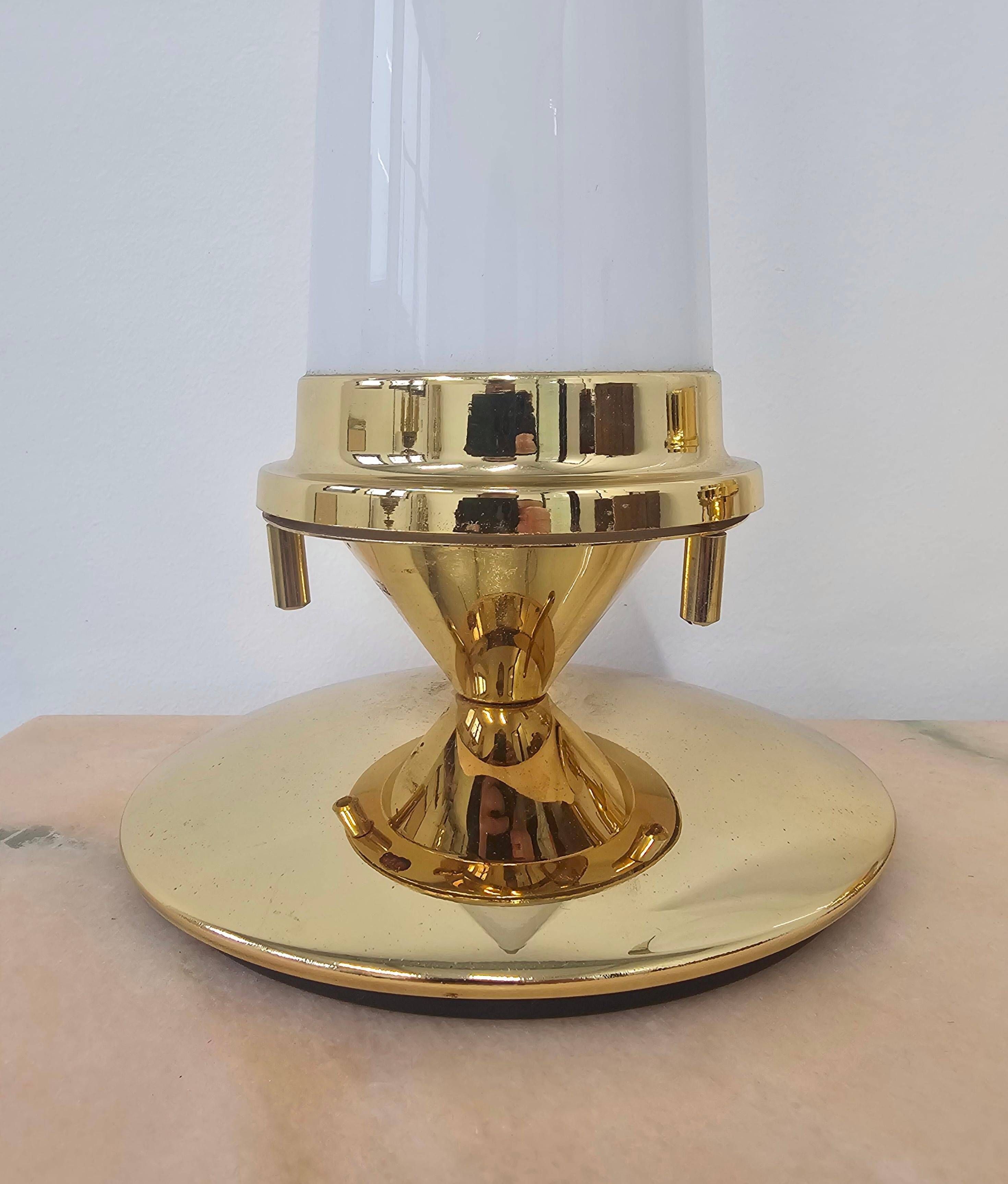 Pair of Hollywood Regency table lamps in brass with glass shades.