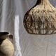 Suspension or rattan lampshade in the shape of a woven bulb.