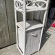 Small white wicker bathroom shelf