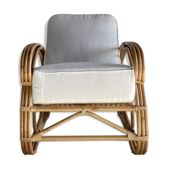 Large rattan rest chair and white cushions