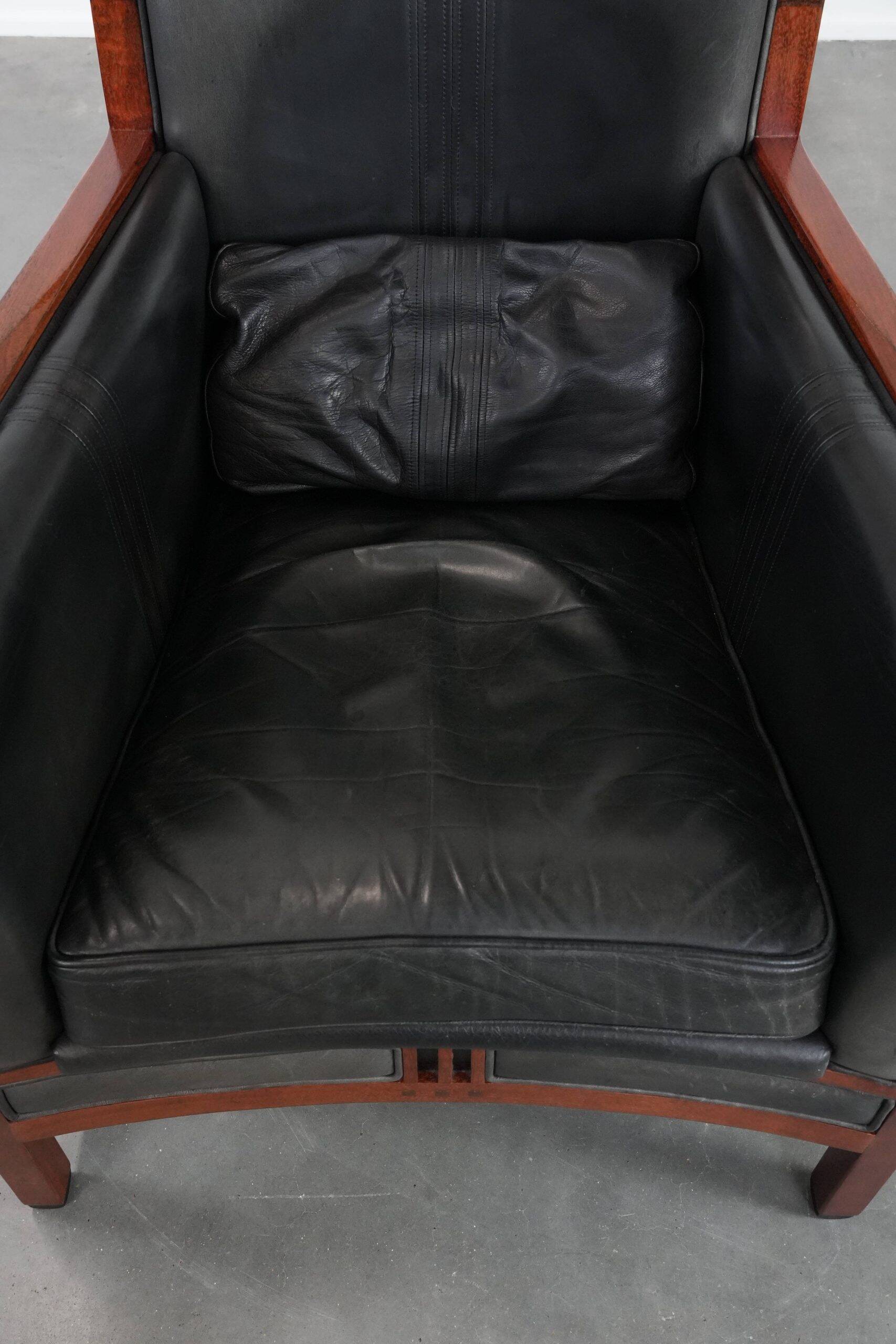 Black Art Deco cowhide leather and wooden design armchair with a high back