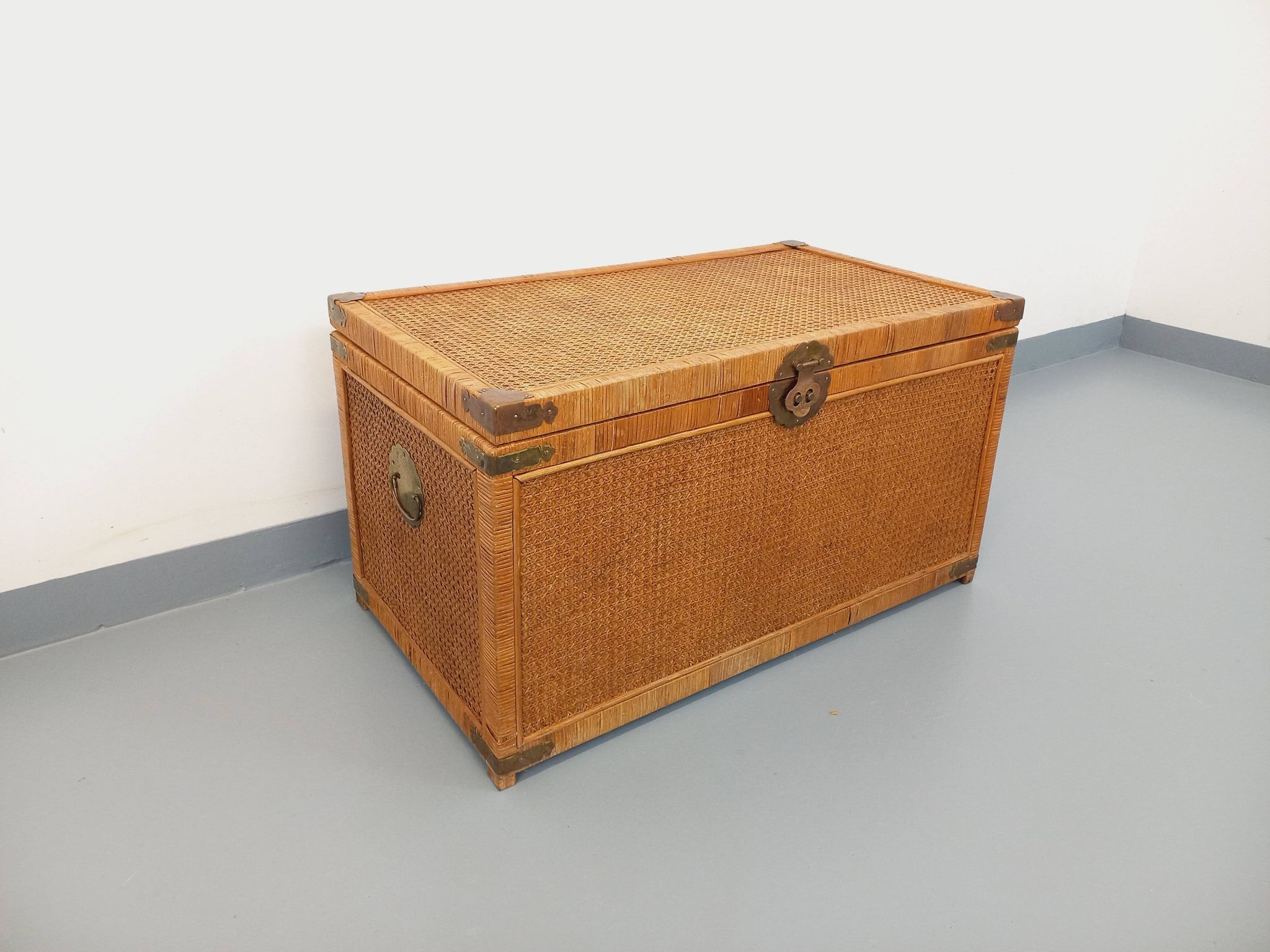 Vintage trunk in wood, rattan, caning, and brass.