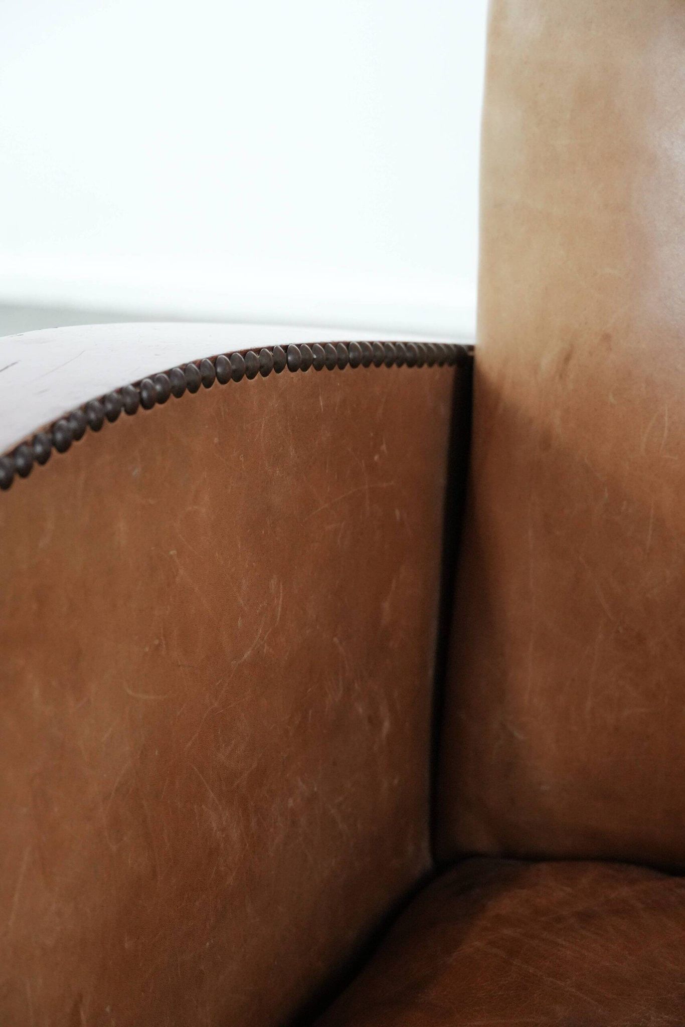 Art Deco design armchair in light cognac cowhide leather.