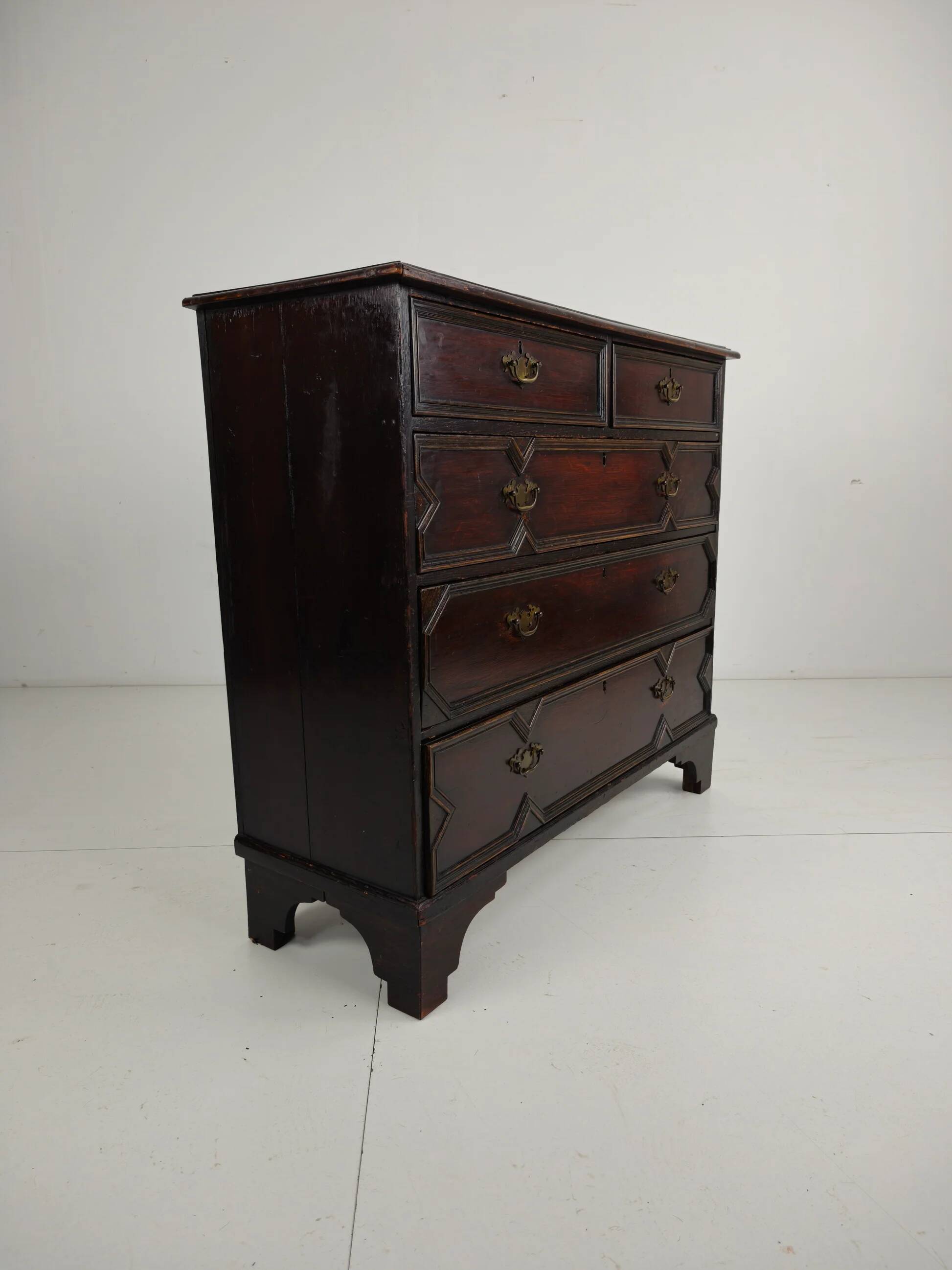English geometric-panelled oak chest of drawers, circa 1680