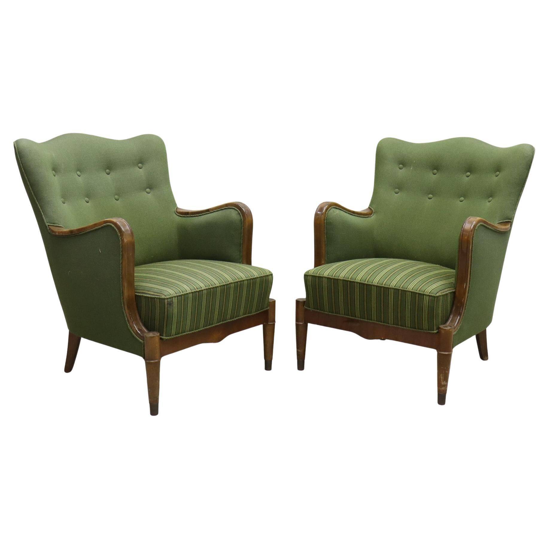 Modern Danish armchairs by Alfred Christensen. Beautiful shape, brass legs.