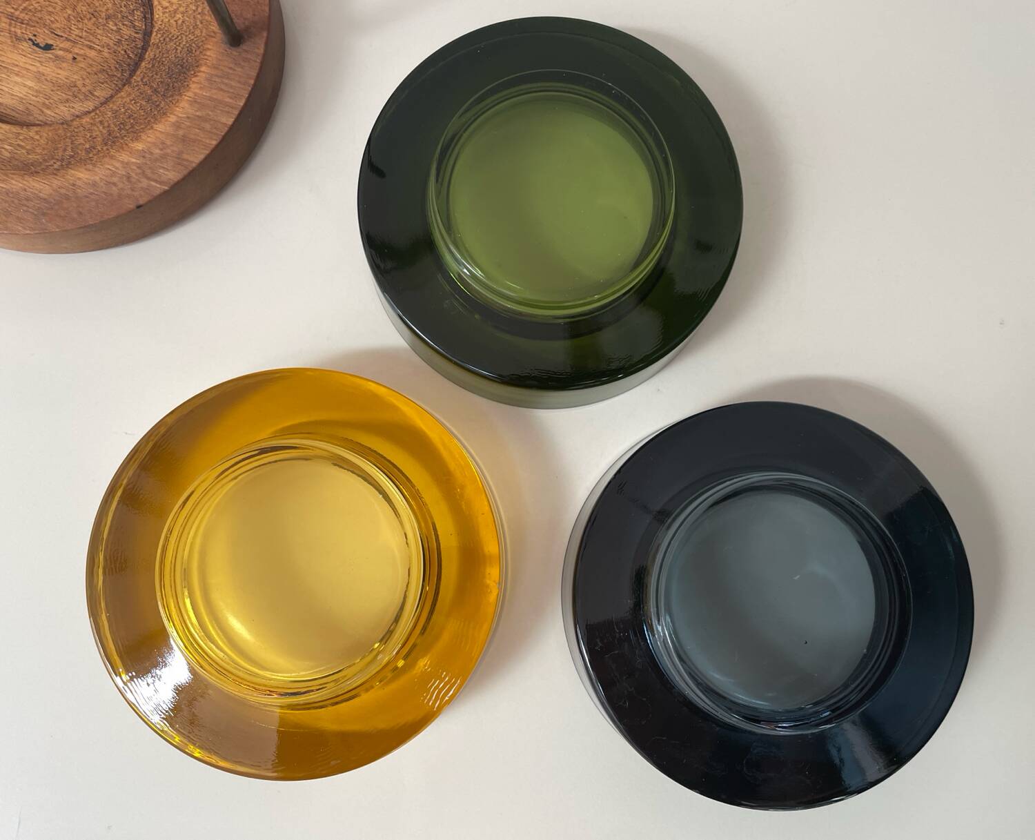 Set of 3 stackable glass catchalls with a teak base.