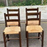 4 solid oak chairs in dark colour with elephant upholstery.