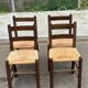 4 solid oak chairs in dark colour with elephant upholstery.
