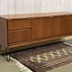 1970s English enfilade in teak with splayed legs.