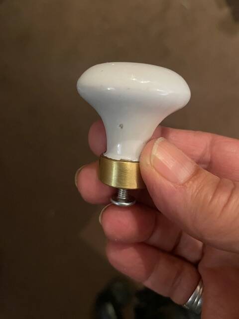 a pair of small antique porcelain and brass knob handles