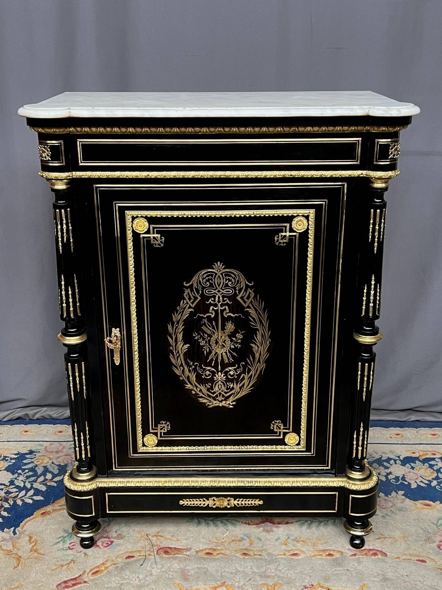 Napoleon III style commode, decorated with brass marquetry and gilded bronze mounts.